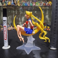 Collectible figure of Sailor Moon (Usagi Tsukino) sitting on a crescent moon