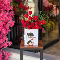 A luxurious flower box filled with natural red Damask roses
